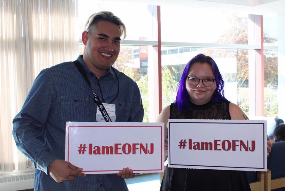 Image of two students holding up signs that say "#IamEOFNJ"