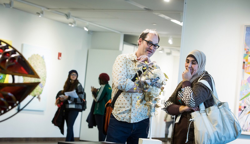 HCCC Professor Michael Lee touring with students through exhibit