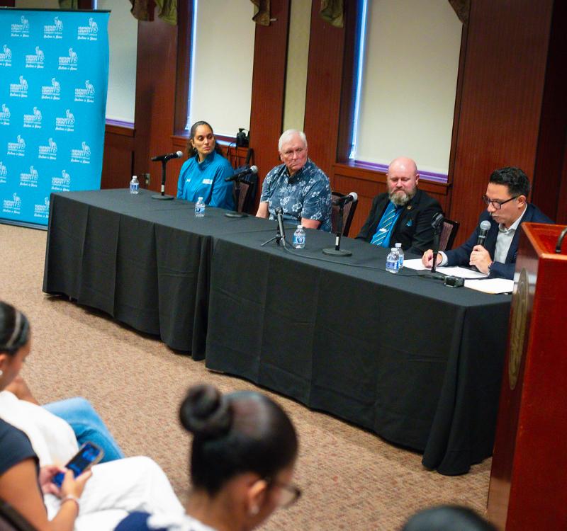 Panelists share insights and engage with attendees during an HCCC discussion event, fostering dialogue and community engagement.