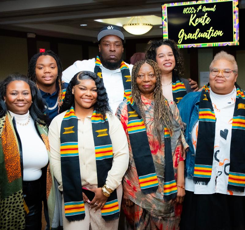 Graduates, family members, and supporters gather for a group photo during HCCC’s Annual Kente Graduation celebration, honoring academic achievement and cultural heritage.