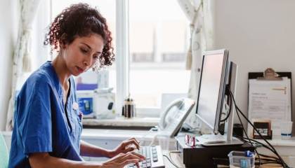 Medical Biller at a computer