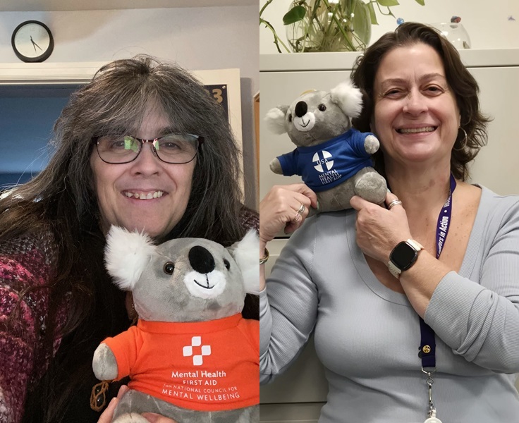 A photo of two trainers holding koala mascots representing mental health first aid, emphasizing training and community support.
